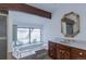 Bright bathroom features a soaking tub, marble countertop, and a decorative mirror at 2045 Pine Wood Rd, Sedalia, CO 80135