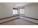 Bright carpeted bedroom with wood trim featuring two large windows providing ample natural light at 2045 Pine Wood Rd, Sedalia, CO 80135
