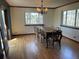 Traditional dining room with chandelier, hardwood floors, and natural light at 2045 Pine Wood Rd, Sedalia, CO 80135