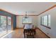 Bright dining room with wood floors and a large window looking out to a forest at 2045 Pine Wood Rd, Sedalia, CO 80135