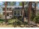 Stone home with well-manicured lawn and mature trees offering ample privacy for outdoor living at 2045 Pine Wood Rd, Sedalia, CO 80135