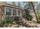 Stone exterior with decorative landscaping and stairs to the entrance at 2045 Pine Wood Rd, Sedalia, CO 80135