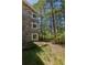 Exterior view of a stone house with multiple windows surrounded by verdant trees, blending elegance with natural beauty at 2045 Pine Wood Rd, Sedalia, CO 80135