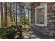 Wooden deck with view to the surrounding pine tree forest at 2045 Pine Wood Rd, Sedalia, CO 80135