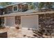 Spacious multi-car garage featuring stone facade and neutral-toned doors, providing ample parking and curb appeal at 2045 Pine Wood Rd, Sedalia, CO 80135