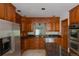Classic kitchen with rich wood cabinetry, granite countertops, and stainless steel appliances at 2045 Pine Wood Rd, Sedalia, CO 80135
