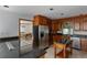 Open kitchen with stainless steel appliances and view into the dining room at 2045 Pine Wood Rd, Sedalia, CO 80135