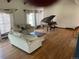 Spacious living room with hardwood floors, bright natural light and cozy seating at 2045 Pine Wood Rd, Sedalia, CO 80135
