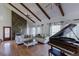Spacious living room featuring hardwood floors, a stone fireplace, and stylish decor at 2045 Pine Wood Rd, Sedalia, CO 80135