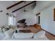 Open living room with high vaulted ceiling, wooden beams, and hardwood floors at 2045 Pine Wood Rd, Sedalia, CO 80135