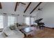Bright living room with hardwood floors, a piano, and comfortable seating at 2045 Pine Wood Rd, Sedalia, CO 80135
