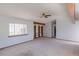 Spacious living room with built in book shelves, ceiling fan, and carpet at 2045 Pine Wood Rd, Sedalia, CO 80135