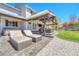 Outdoor oasis with a covered patio, lounge chairs, a hot tub, and a well-manicured backyard at 5912 Randolph Ave, Castle Rock, CO 80104