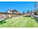 Large backyard featuring artificial grass, a trampoline, seating, and easy access to the home's exterior at 5912 Randolph Ave, Castle Rock, CO 80104