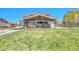 Spacious backyard with a covered patio, outdoor seating, and a lush lawn perfect for outdoor activities at 5912 Randolph Ave, Castle Rock, CO 80104