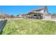 Expansive backyard with a covered patio, a playground, and lush green grass, creating an ideal space for outdoor enjoyment at 5912 Randolph Ave, Castle Rock, CO 80104