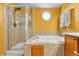 Bathroom featuring a glass-enclosed shower, soaker tub, octagon window, and neutral tile at 5912 Randolph Ave, Castle Rock, CO 80104