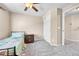 A cozy bedroom featuring gray carpeting and a ceiling fan at 5912 Randolph Ave, Castle Rock, CO 80104