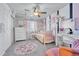 Bright bedroom with a cute pink and white theme, large window, ceiling fan, and neutral carpet at 5912 Randolph Ave, Castle Rock, CO 80104
