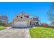 Beautiful two-story home with brick and siding exterior, a well-kept lawn, and a welcoming front porch at 5912 Randolph Ave, Castle Rock, CO 80104