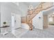 Bright foyer with hardwood floors and a staircase leading to the upper level of the home at 5912 Randolph Ave, Castle Rock, CO 80104