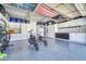 Spacious garage with epoxy floors, white cabinets, storage, and plenty of room for vehicles and projects at 5912 Randolph Ave, Castle Rock, CO 80104
