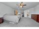 Open main bedroom layout features neutral carpet, access to the bathroom, and a ceiling fan at 5912 Randolph Ave, Castle Rock, CO 80104