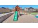 Backyard playground area featuring a wooden playset with a slide, swings, and climbing features for to enjoy at 5912 Randolph Ave, Castle Rock, CO 80104