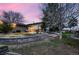 Inviting backyard featuring a stone patio, lush greenery, mature trees, and a serene ambiance at 1062 Jasper St, Aurora, CO 80011