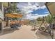 Inviting backyard patio with dining set, swing, and storage shed at 1062 Jasper St, Aurora, CO 80011