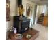 Finished basement featuring a black stove with brick accents and staircase access at 1062 Jasper St, Aurora, CO 80011