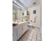 Bright bathroom featuring a shower, vanity, and a toilet at 1062 Jasper St, Aurora, CO 80011