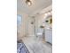 Bright bathroom with a glass-enclosed shower, tile floors, and modern fixtures at 1062 Jasper St, Aurora, CO 80011