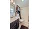 Bathroom features a shower with tile surround, a vanity and toilet at 1062 Jasper St, Aurora, CO 80011