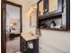 Bathroom view with vanity, mirror and open view into bedroom at 1062 Jasper St, Aurora, CO 80011