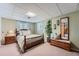 Charming bedroom with soft lighting, a comfortable bed, and decorative mirror and bench at 1062 Jasper St, Aurora, CO 80011