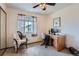 Cozy bedroom with a desk and a chair beside the window at 1062 Jasper St, Aurora, CO 80011