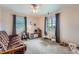Spacious bedroom area features play area, large window and ceiling fan at 1062 Jasper St, Aurora, CO 80011