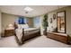 Comfortable bedroom with soft lighting, a inviting bed, and decorative mirror and bench at 1062 Jasper St, Aurora, CO 80011
