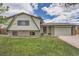 Charming two-story home with landscaped lawn, covered porch, and attached two-car garage at 1062 Jasper St, Aurora, CO 80011