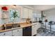 Charming kitchen with white cabinets, butcher block countertops, black appliances, and a breakfast nook at 1062 Jasper St, Aurora, CO 80011