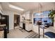 Bright kitchen with butcher block countertops, black appliances, white cabinets, and adjacent breakfast nook at 1062 Jasper St, Aurora, CO 80011