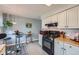 Modern kitchen featuring butcher block countertops, sleek appliances, and a stylish breakfast nook for casual dining at 1062 Jasper St, Aurora, CO 80011