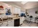 Bright kitchen featuring white cabinets, butcher block countertops, black appliances, and a charming breakfast nook at 1062 Jasper St, Aurora, CO 80011
