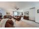 Cozy living room featuring plush leather furniture, soft carpeting, and natural light at 1062 Jasper St, Aurora, CO 80011