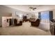 Bright living room featuring plush leather furniture, soft carpeting, and natural light at 1062 Jasper St, Aurora, CO 80011