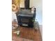 Close-up of the stove on the brick hearth with decorative vases and house plant at 1062 Jasper St, Aurora, CO 80011