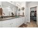 Stylish bathroom boasts a double vanity, sleek countertops, and modern lighting at 12570 Boggs St, Parker, CO 80134
