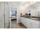 Elegant bathroom features a double vanity, modern fixtures, and a glass-enclosed shower at 12570 Boggs St, Parker, CO 80134