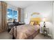 Comfortable bedroom with large window, a desk and carpet floors that provides comfort and relaxation at 12570 Boggs St, Parker, CO 80134